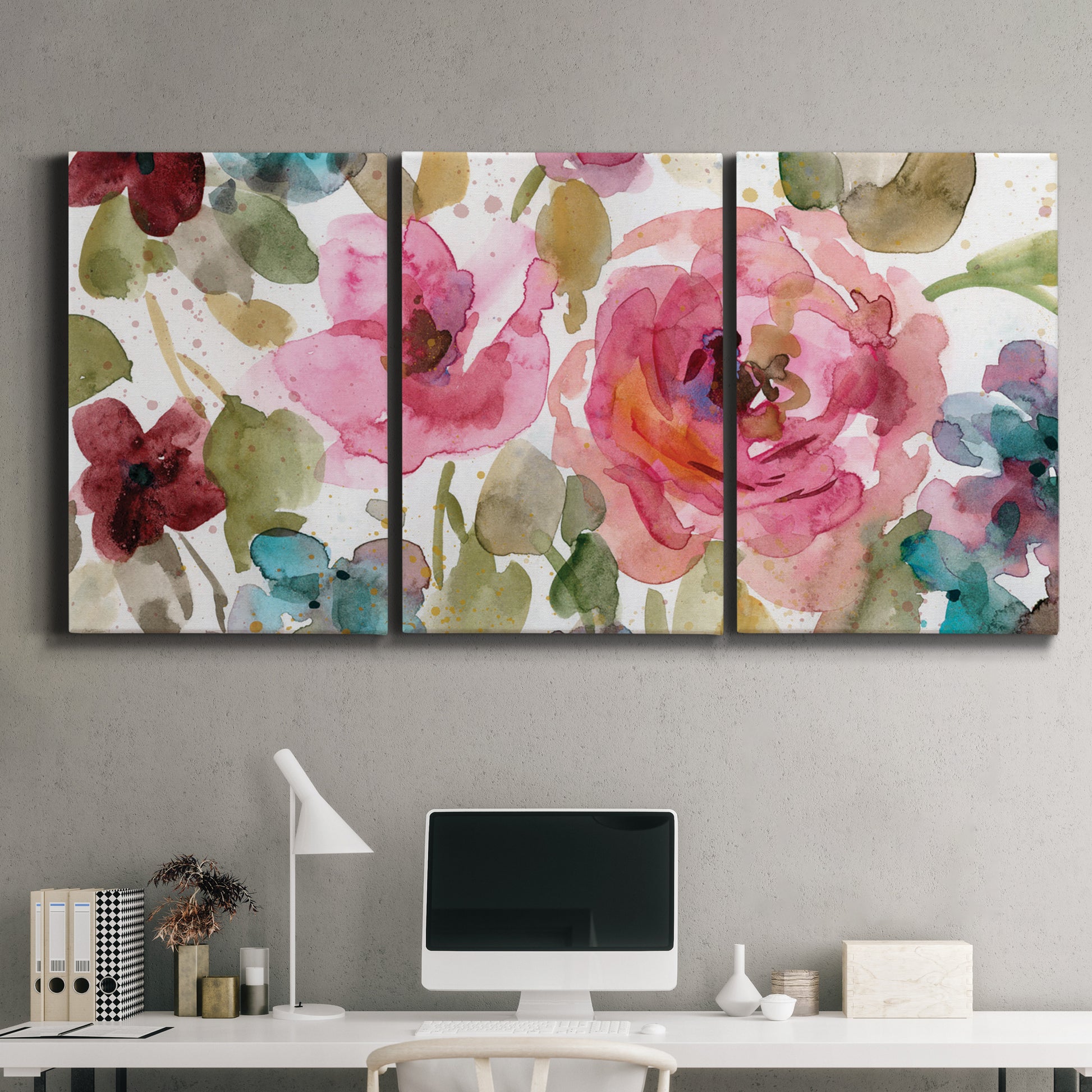 Three-panel canvas wall art featuring colorful floral watercolor composition, displayed above a desk in a home office.