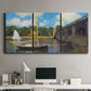 Three-panel canvas wall art featuring bridge crossing river landscape, displayed above a desk in a home office.