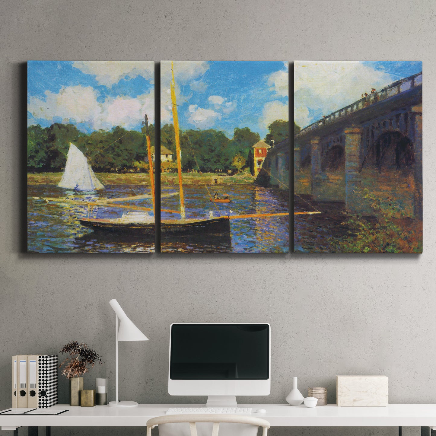 Three-panel canvas wall art featuring bridge crossing river landscape, displayed above a desk in a home office.