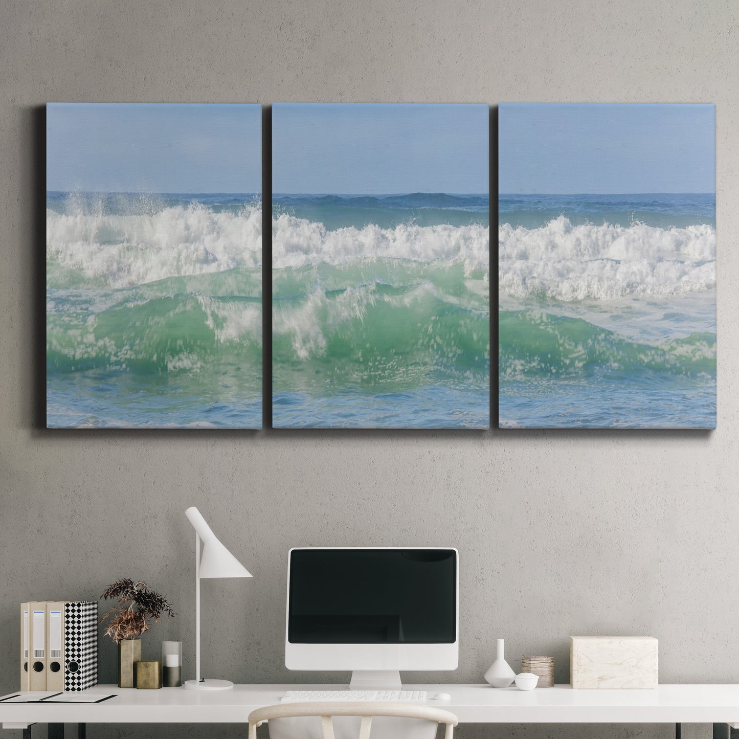 Three-panel canvas wall art featuring coastal waves breaking ashore, displayed above a desk in a home office.