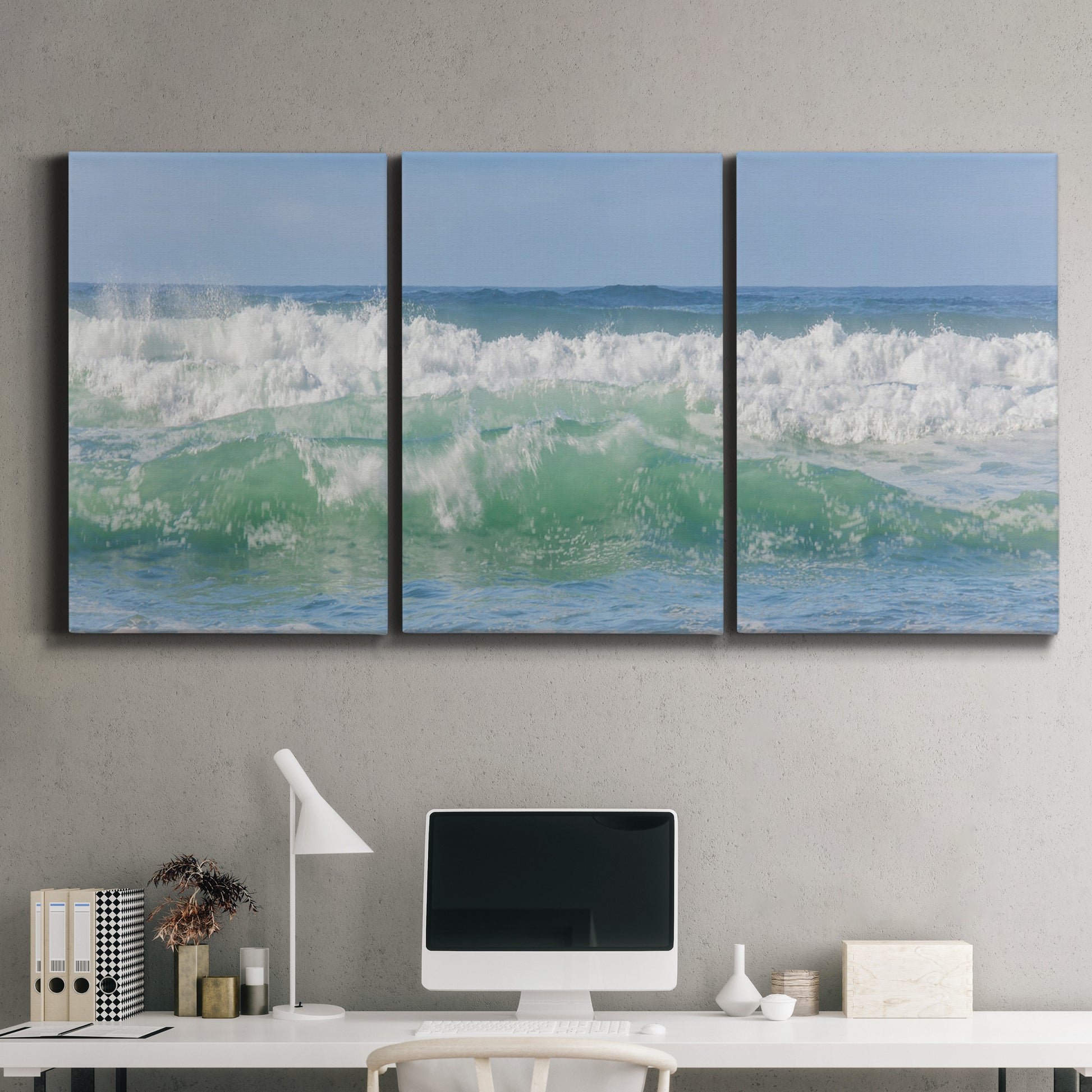 Three-panel canvas wall art featuring coastal waves breaking ashore, displayed above a desk in a home office.