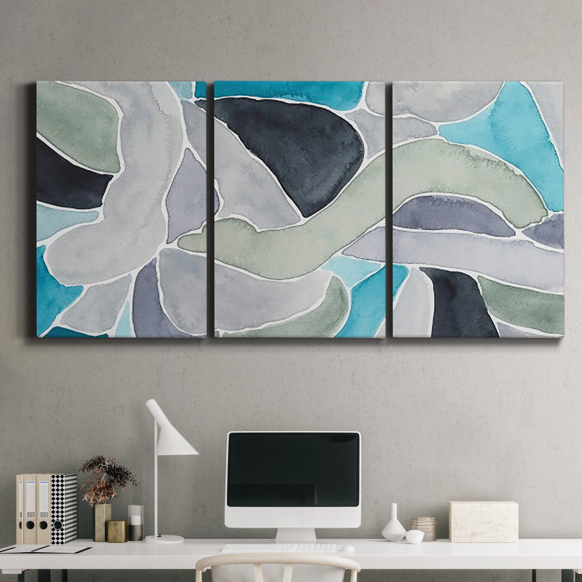 Three-panel canvas wall art featuring subtle abstract billowing color layers, displayed above a desk in a home office.