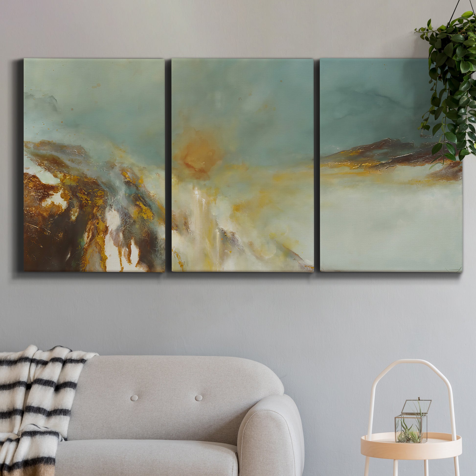 Three-panel canvas wall art featuring earth toned abstract solar landscape, displayed in a modern living room above a sofa.