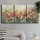 Three-panel canvas wall art featuring colorful garden flowers in bloom, displayed in a modern living room above a sofa.