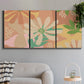 Three-panel canvas wall art featuring neutral toned botanical floral silhouettes, displayed in a modern living room above a sofa.