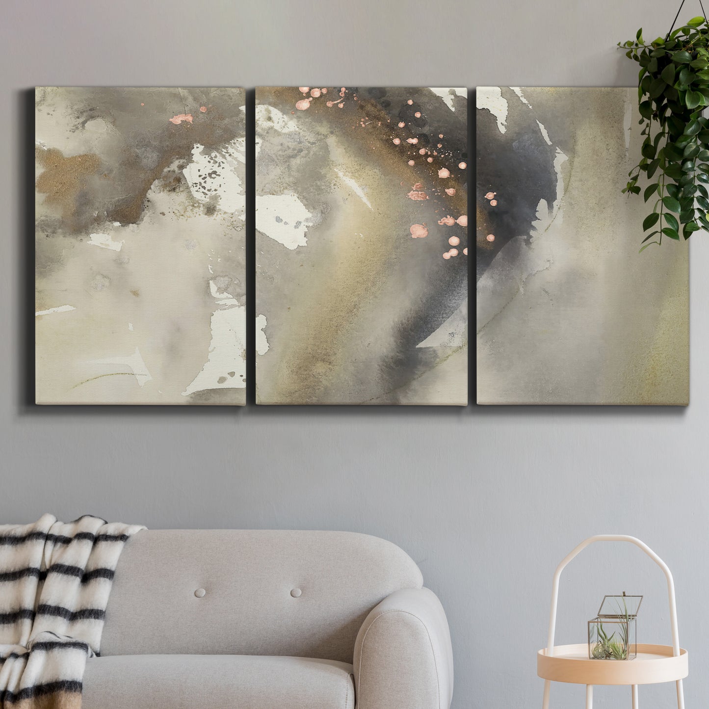 Three-panel canvas wall art featuring flowing abstract wave motion, displayed in a modern living room above a sofa.