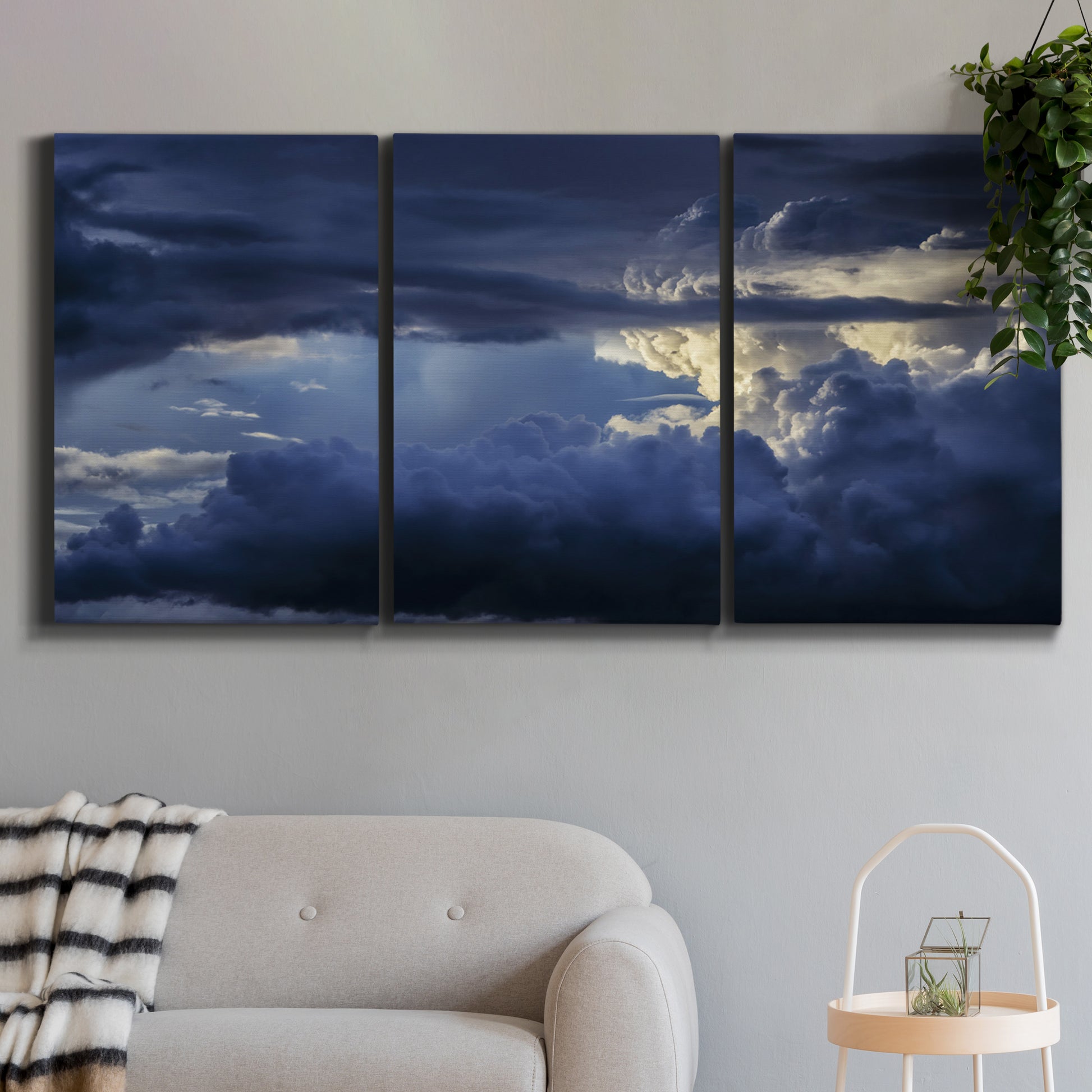 Three-panel canvas wall art featuring hot air balloons rising at dawn, displayed in a modern living room above a sofa.