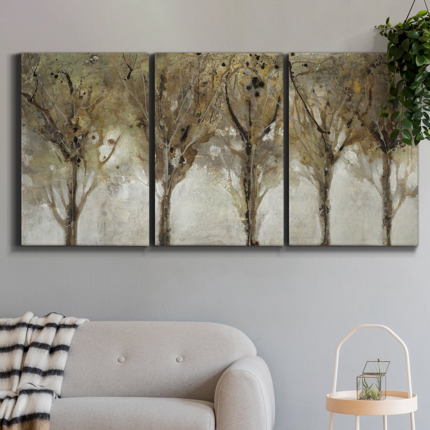 Three-panel canvas wall art featuring sunlight filtering through trees, displayed in a modern living room above a sofa.