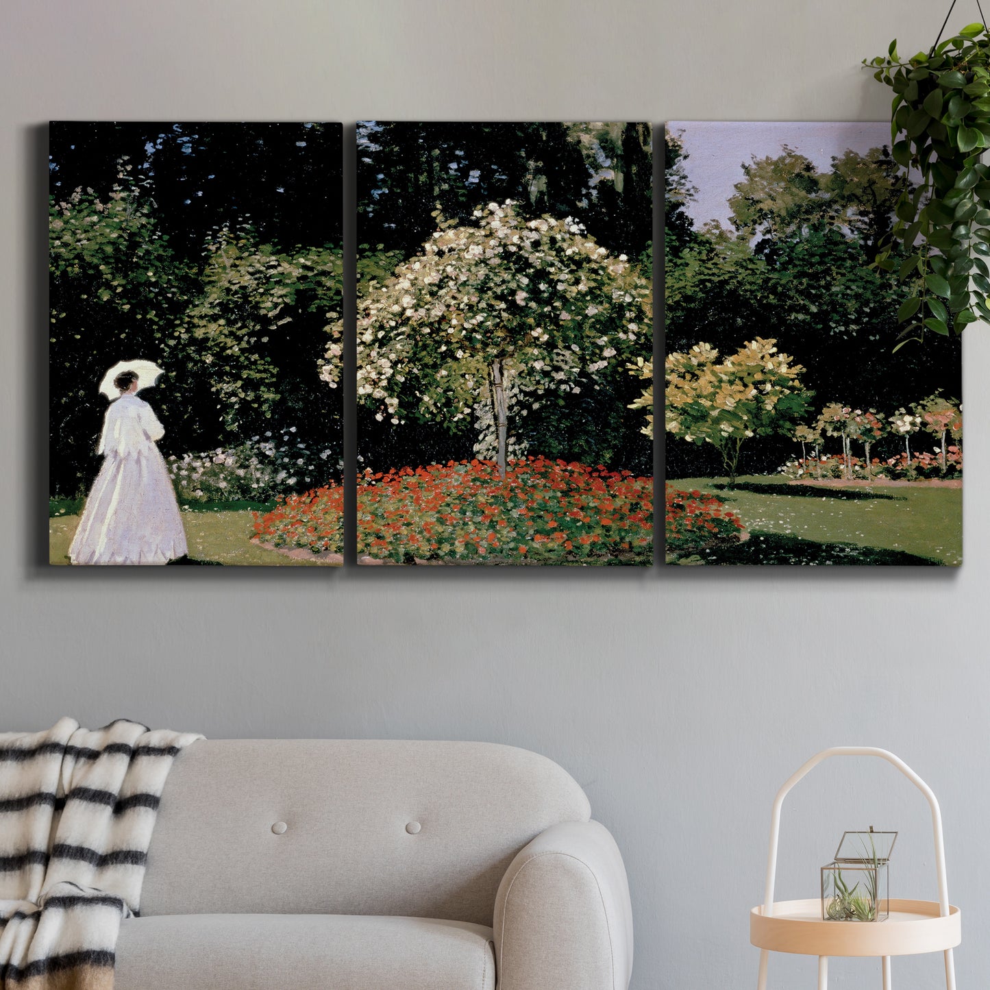 Three-panel canvas wall art featuring woman seated in garden landscape, displayed in a modern living room above a sofa.