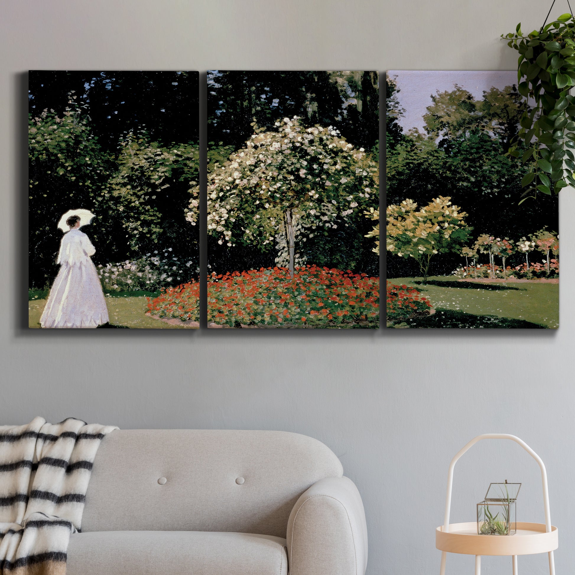 Three-panel canvas wall art featuring woman seated in garden landscape, displayed in a modern living room above a sofa.