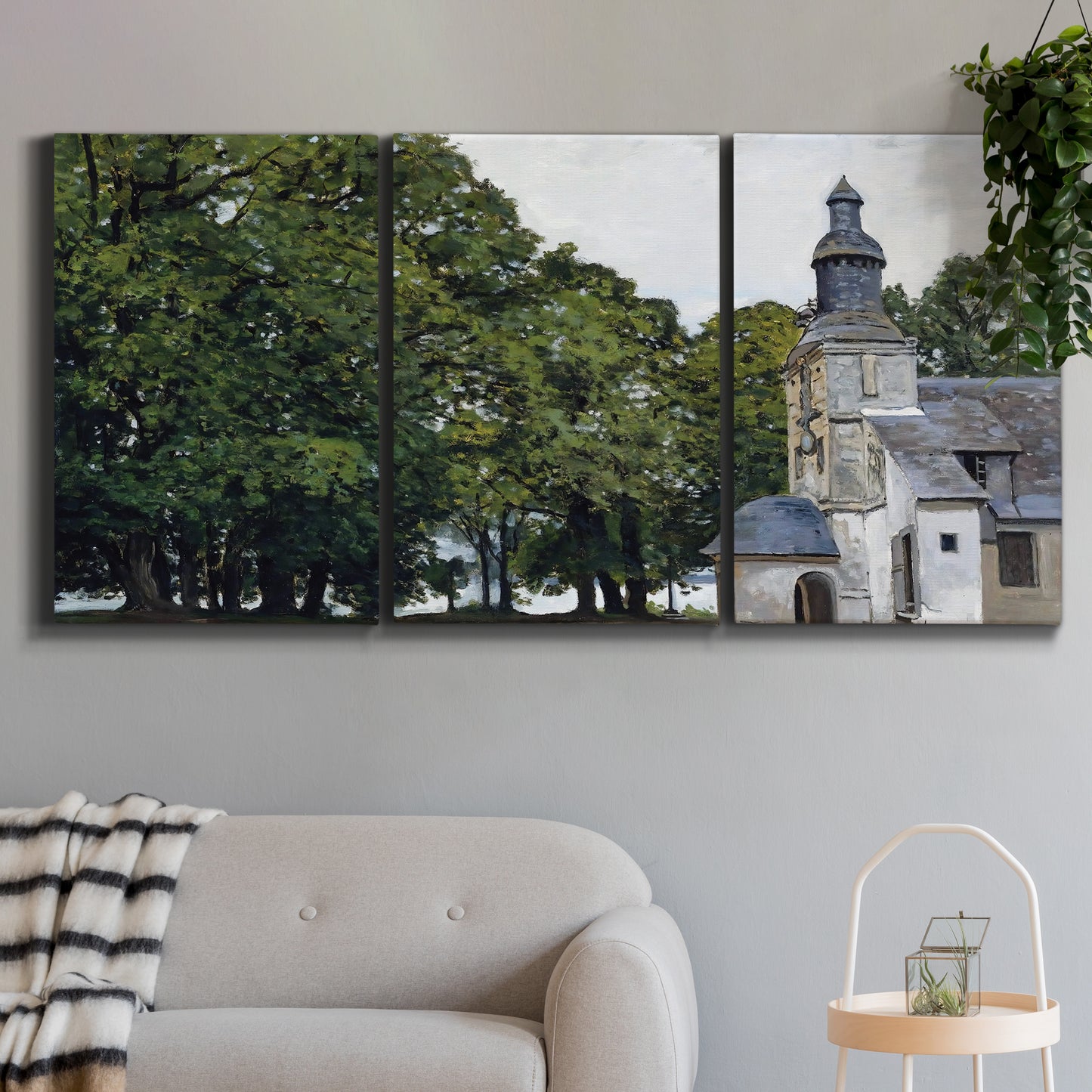 Three-panel canvas wall art featuring chapel building in rural setting, displayed in a modern living room above a sofa.