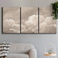 Three-panel canvas wall art featuring soft whimsical cloudscape, displayed in a modern living room above a sofa.