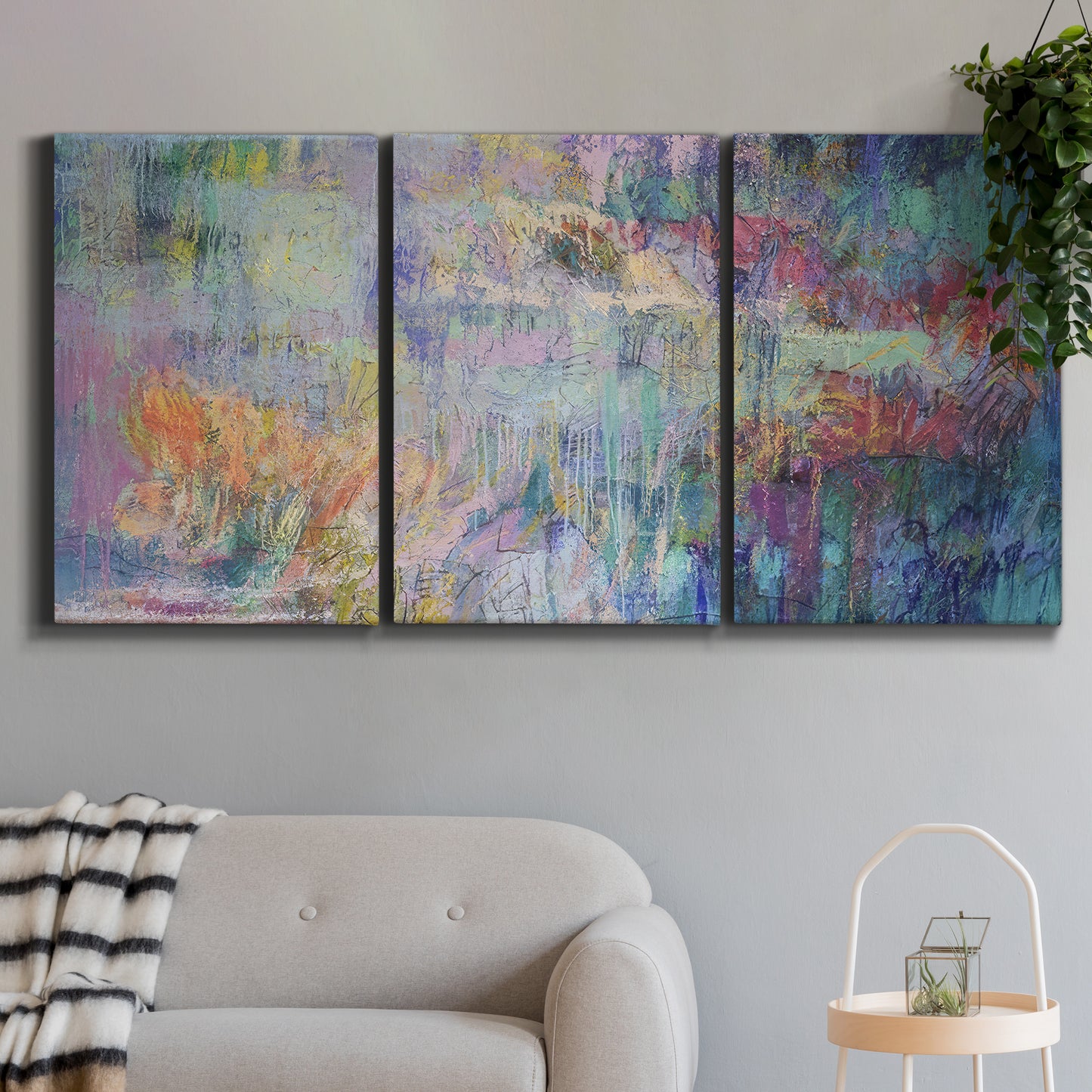 Three-panel canvas wall art featuring abstract evening landscape with depth, displayed in a modern living room above a sofa.
