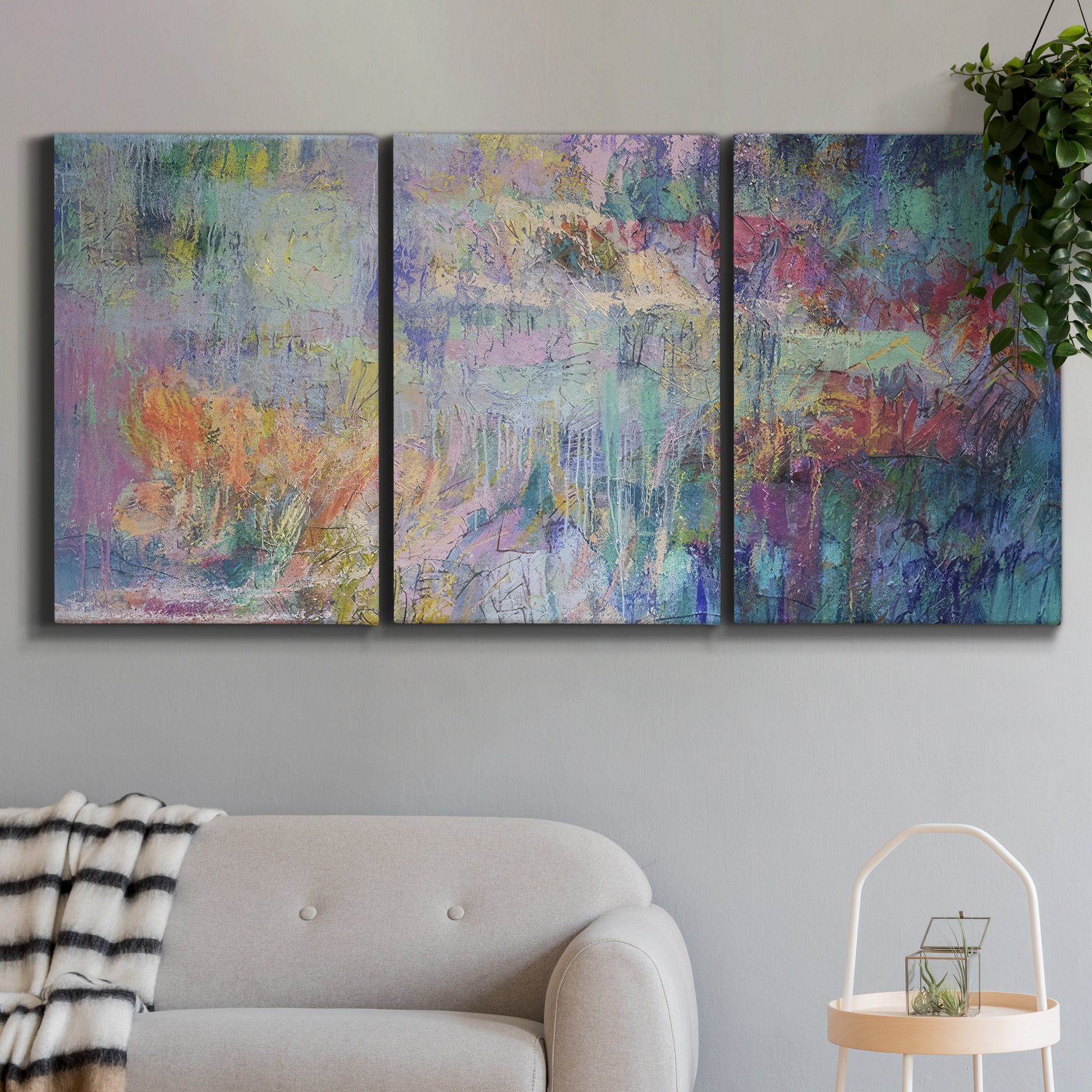 Three-panel canvas wall art featuring abstract evening landscape with depth, displayed in a modern living room above a sofa.