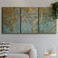 Three-panel canvas wall art featuring earthy copper toned abstract, displayed in a modern living room above a sofa.