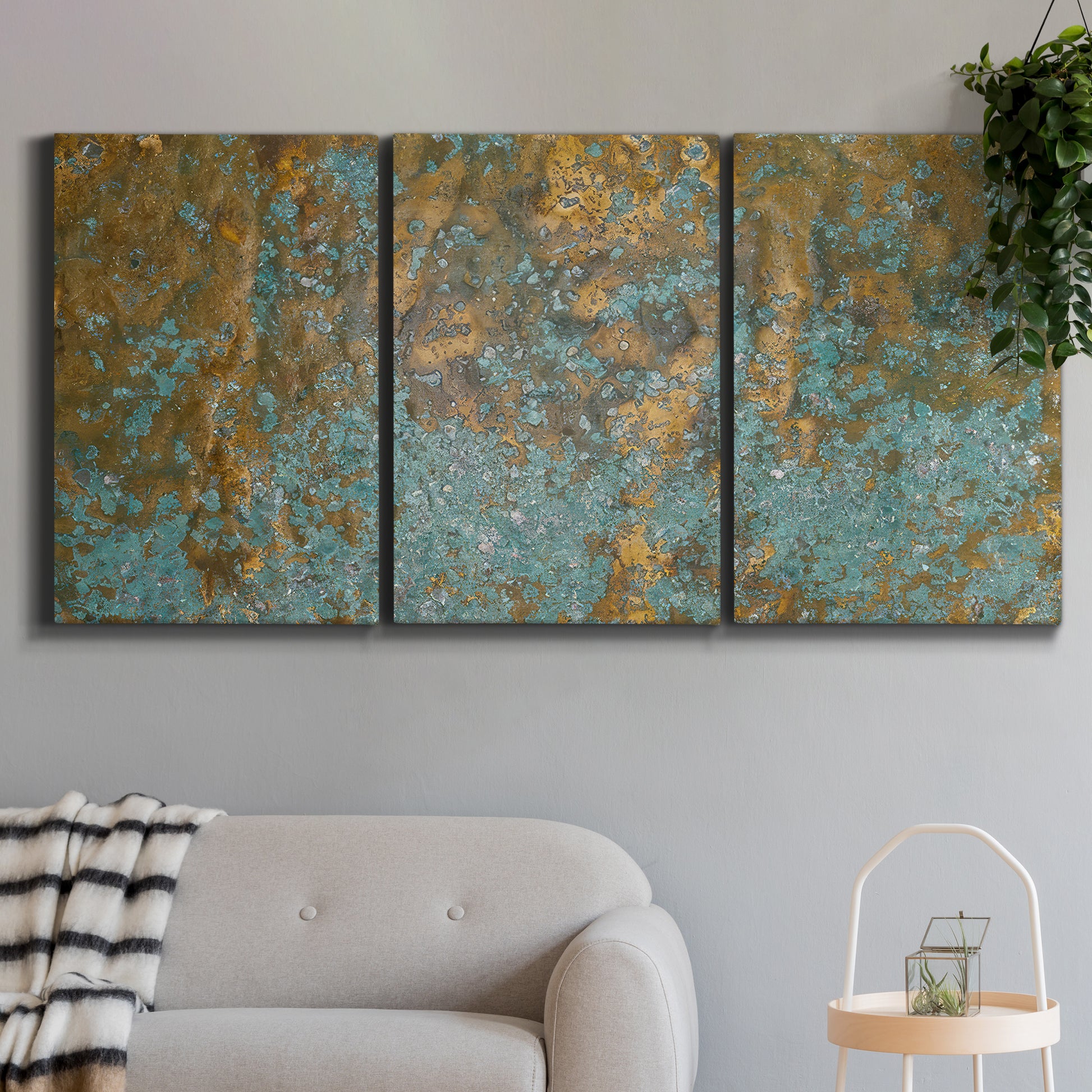 Three-panel canvas wall art featuring earthy copper toned abstract, displayed in a modern living room above a sofa.
