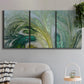 Three-panel canvas wall art featuring layered modern abstract landscape, displayed in a modern living room above a sofa.