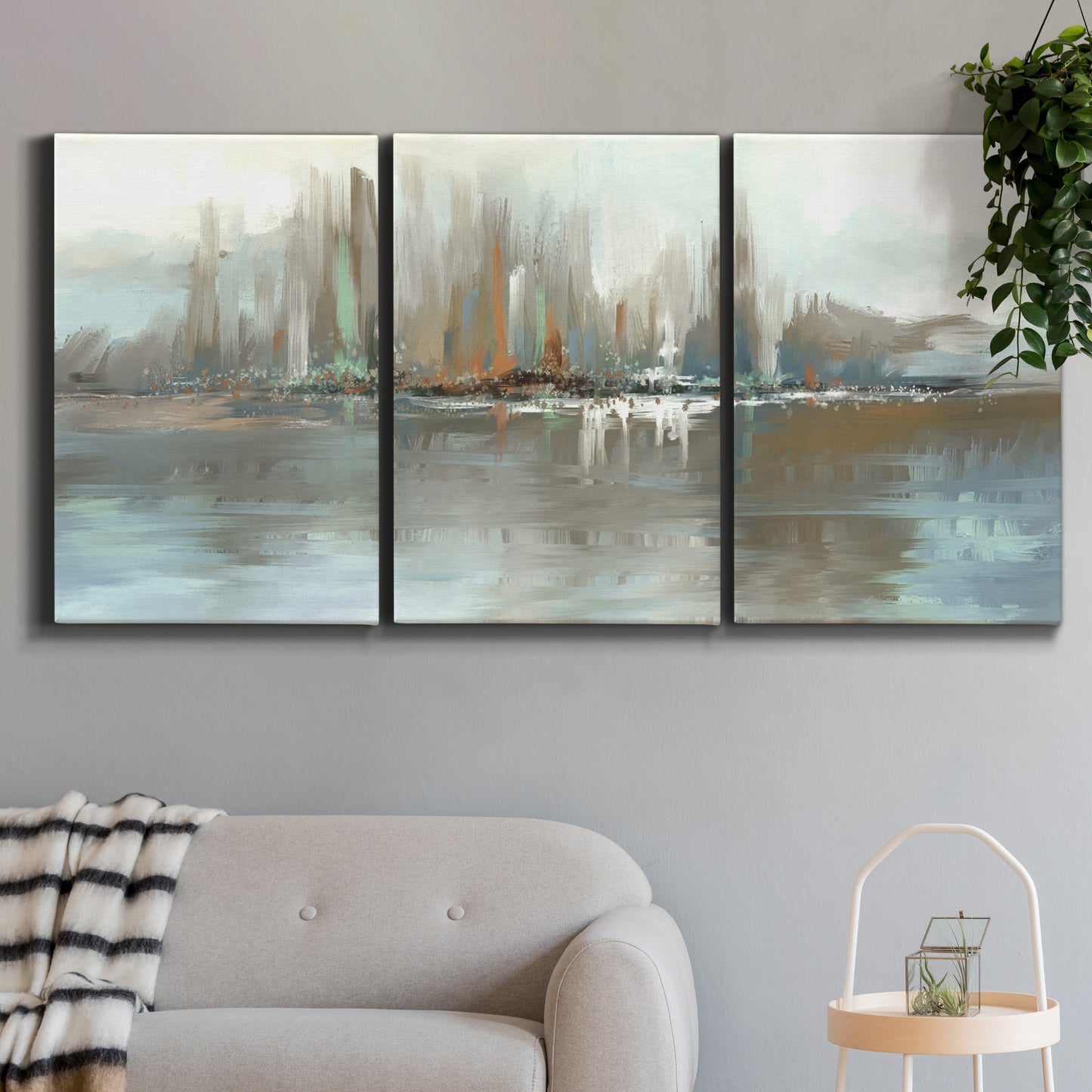 Three-panel canvas wall art featuring glowing abstract city lights, displayed in a modern living room above a sofa.