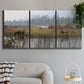 Three-panel canvas wall art featuring wildlife walking through open field, displayed in a modern living room above a sofa.