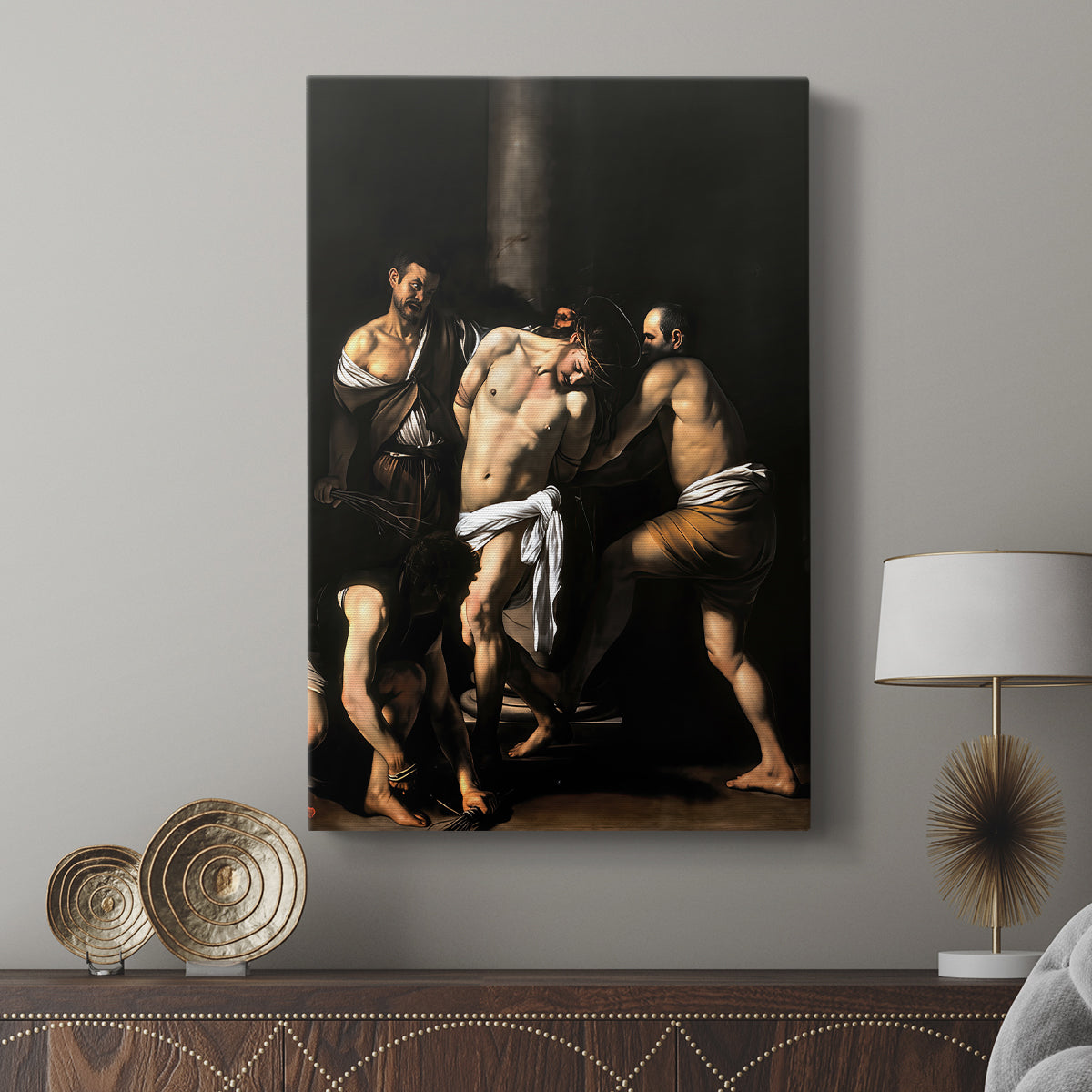 Canvas art print featuring a religious scene with muscular forms and dark background displayed in a modern interior space.