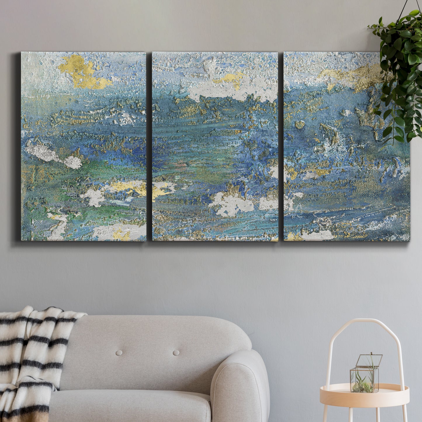 Three-panel canvas wall art featuring sparkling abstract sea surface, displayed in a modern living room above a sofa.
