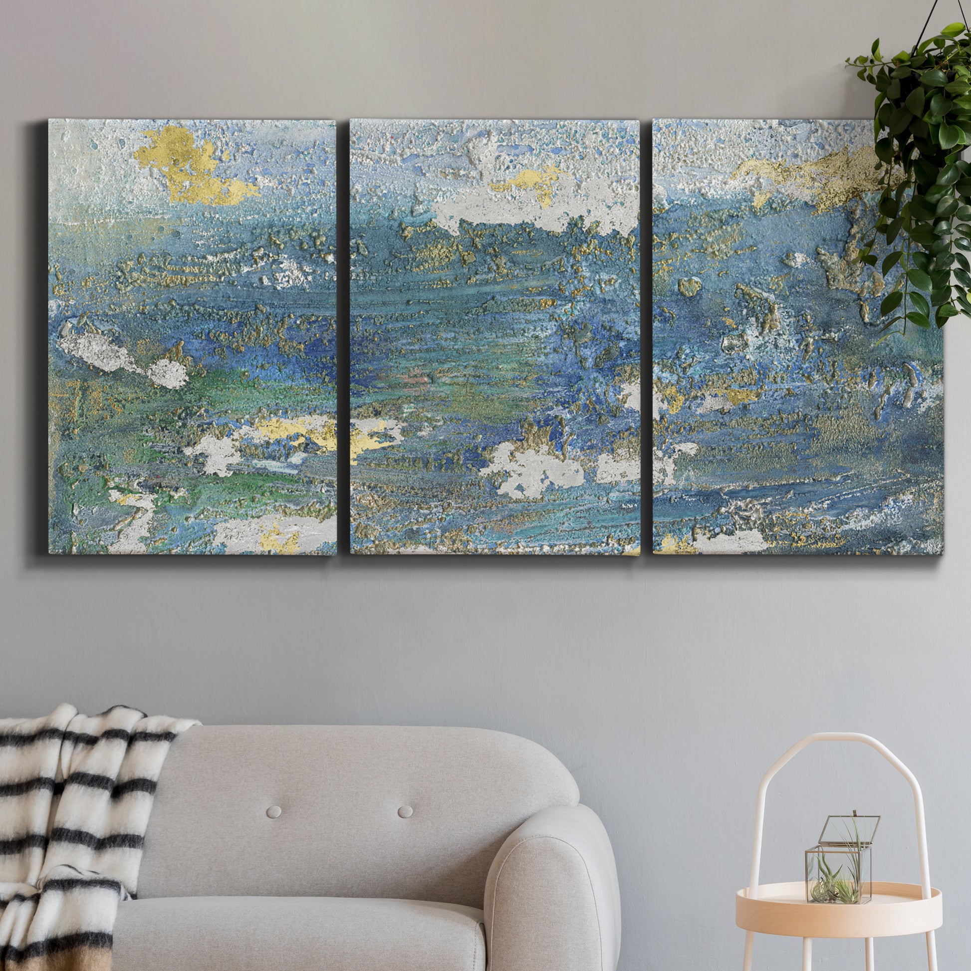 Three-panel canvas wall art featuring sparkling abstract sea surface, displayed in a modern living room above a sofa.