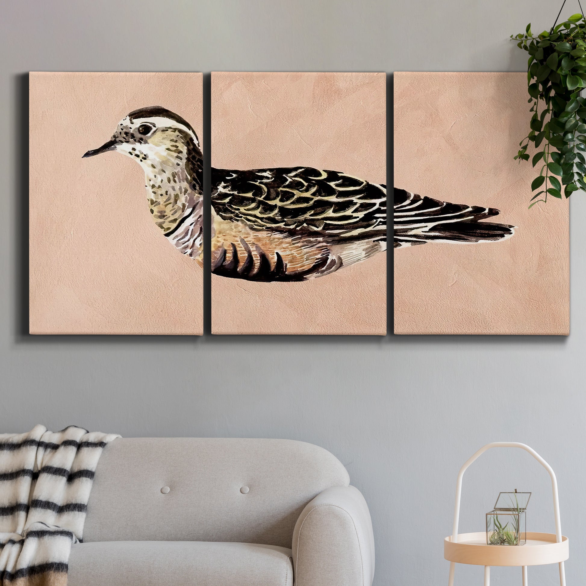 Three-panel canvas wall art featuring coastal bird illustration, displayed in a modern living room above a sofa.