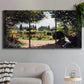 Three-panel canvas wall art featuring coastal garden overlooking sea, displayed in a modern living room above a sofa.