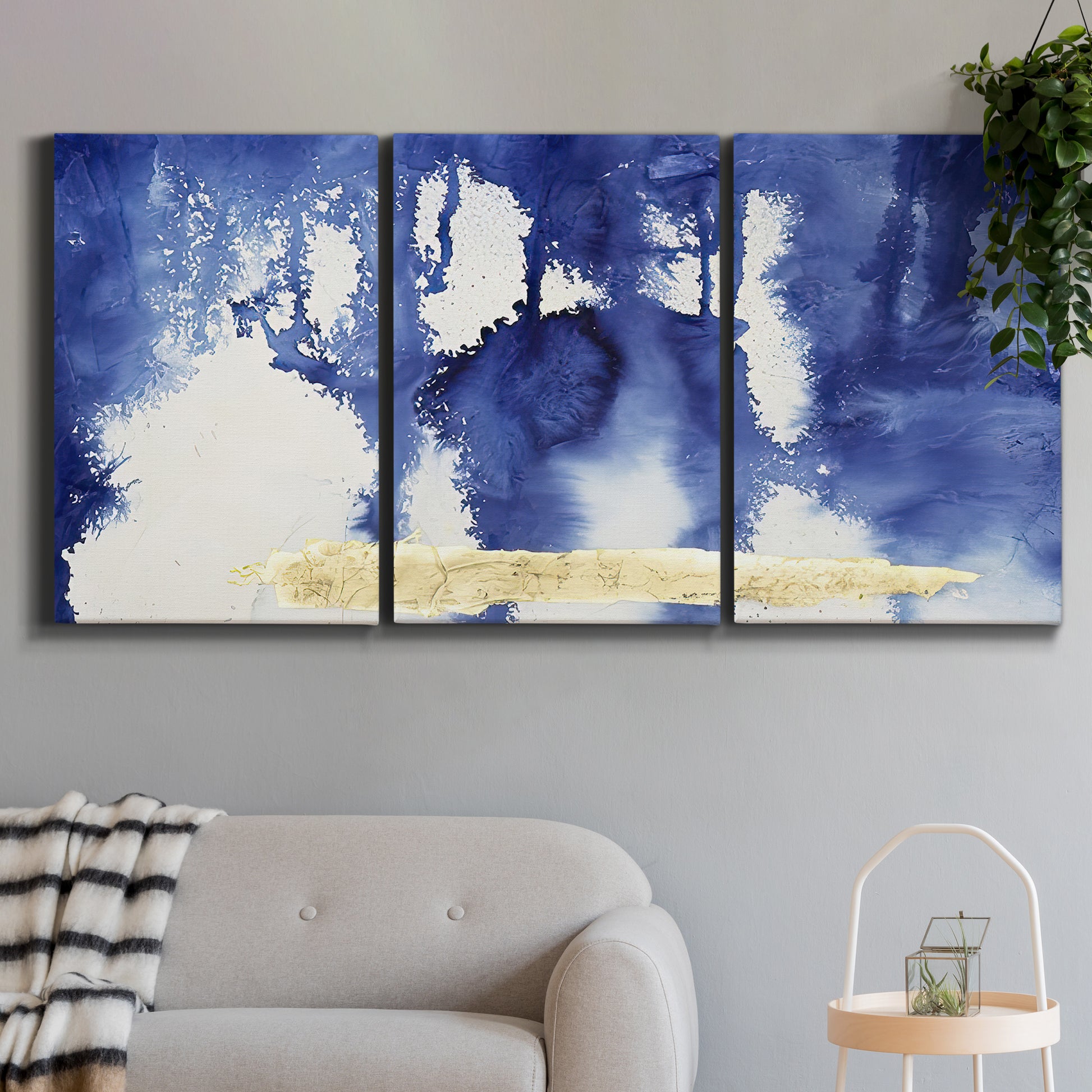 Three-panel canvas wall art featuring saturated abstract color fields, displayed in a modern living room above a sofa.