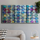 Three-panel canvas wall art featuring contrasting geometric abstract variations, displayed in a modern living room above a sofa.
