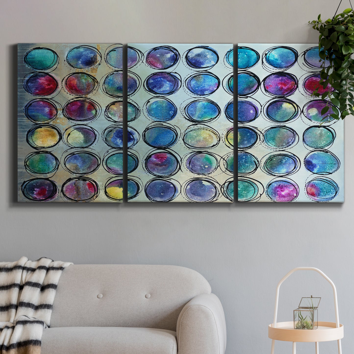 Three-panel canvas wall art featuring contrasting geometric abstract variations, displayed in a modern living room above a sofa.