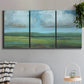 Three-panel canvas wall art featuring wide valley landscape with rolling hills, displayed in a modern living room above a sofa.