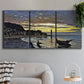 Three-panel canvas wall art featuring river at dusk with fading light, displayed in a modern living room above a sofa.