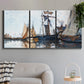 Three-panel canvas wall art featuring fishing boats navigating open water, displayed in a modern living room above a sofa.
