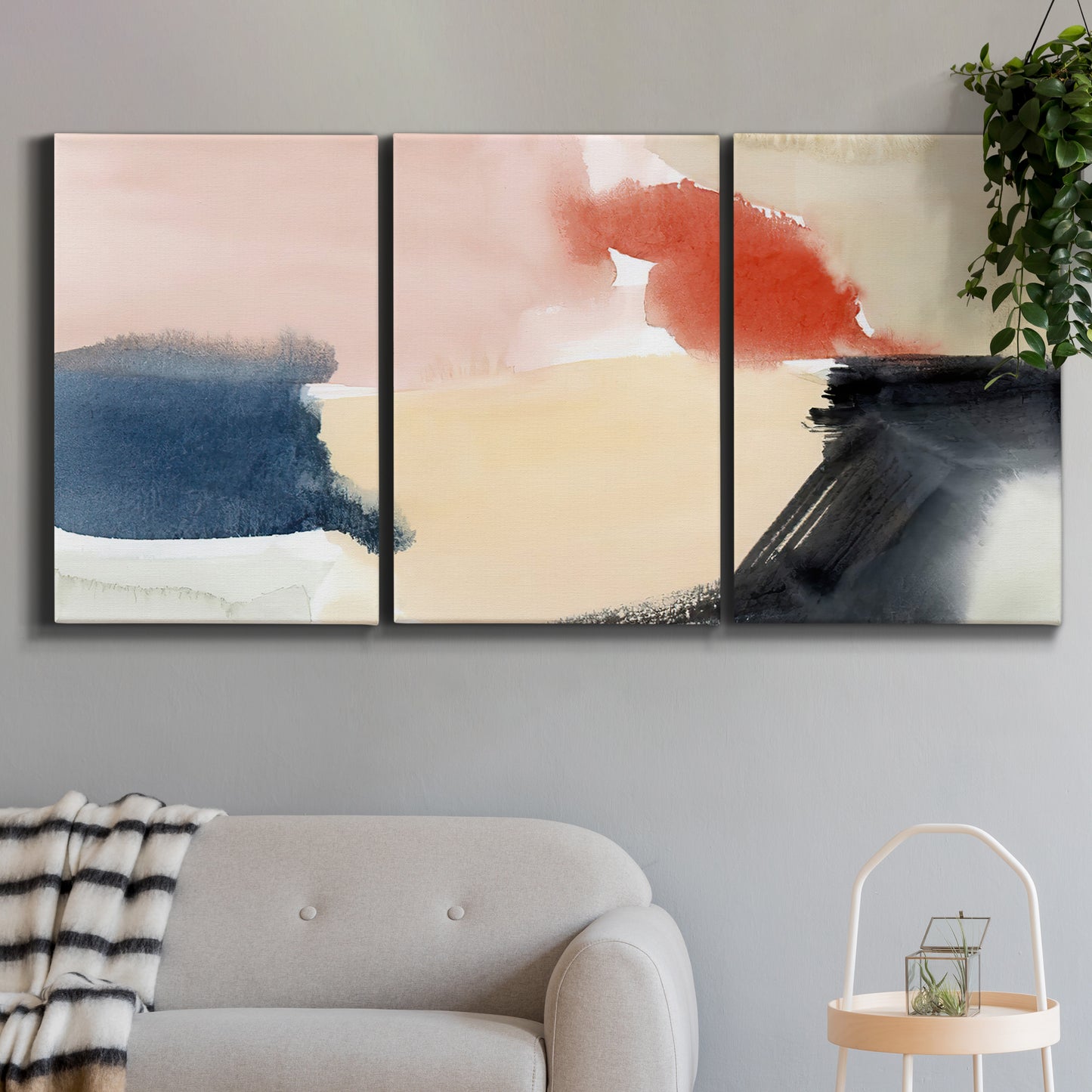 Three-panel canvas wall art featuring playful abstract watercolor shapes, displayed in a modern living room above a sofa.