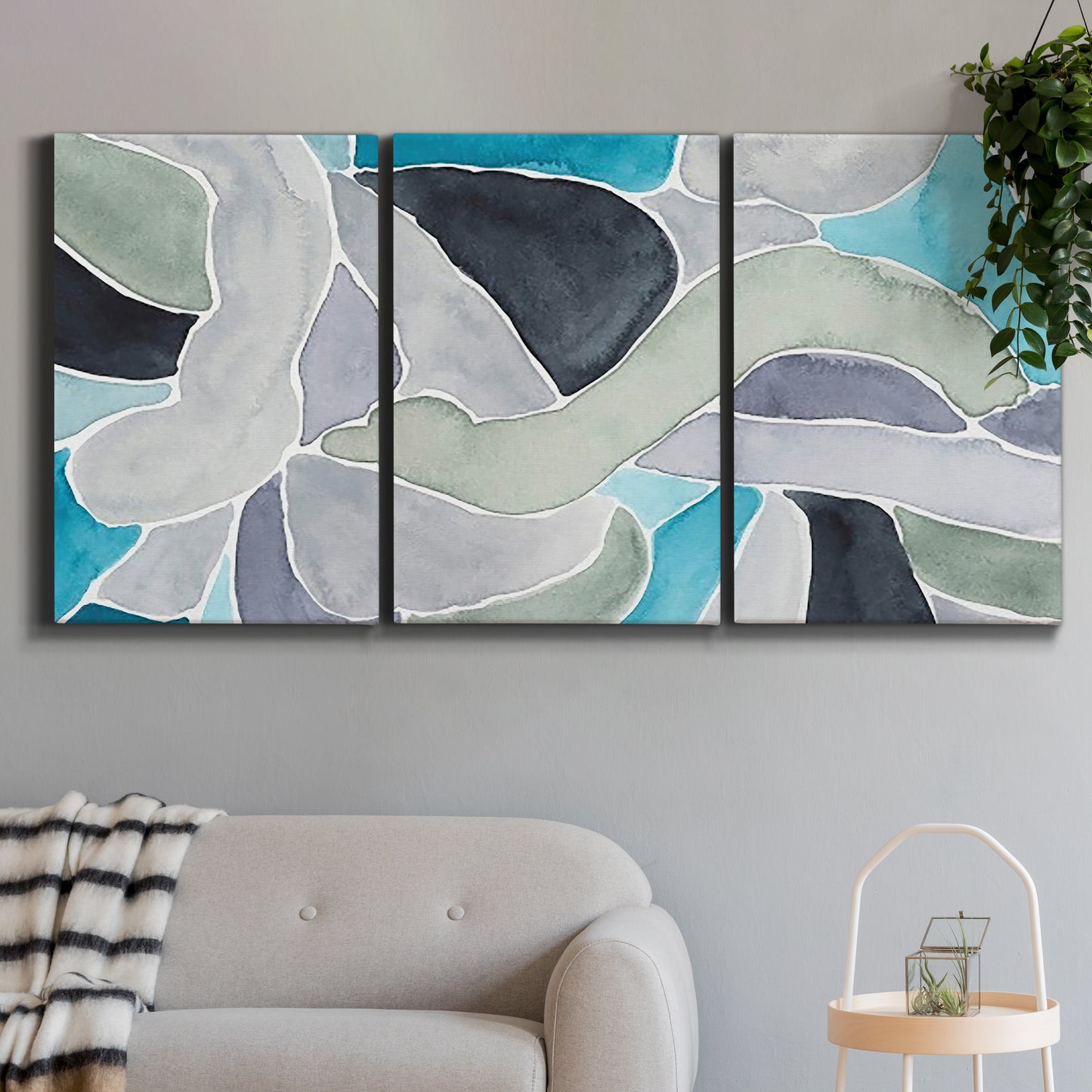 Three-panel canvas wall art featuring subtle abstract billowing color layers, displayed in a modern living room above a sofa.