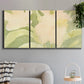 Three-panel canvas wall art featuring minimal verdant floral abstraction, displayed in a modern living room above a sofa.