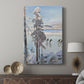 Canvas art print featuring a Nordic winter scene with people gliding across a frozen lake displayed in a modern interior space.