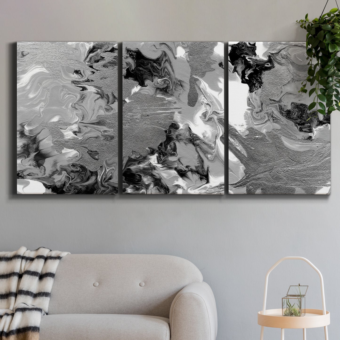 Three-panel canvas wall art featuring abstract marble texture composition, displayed in a modern living room above a sofa.