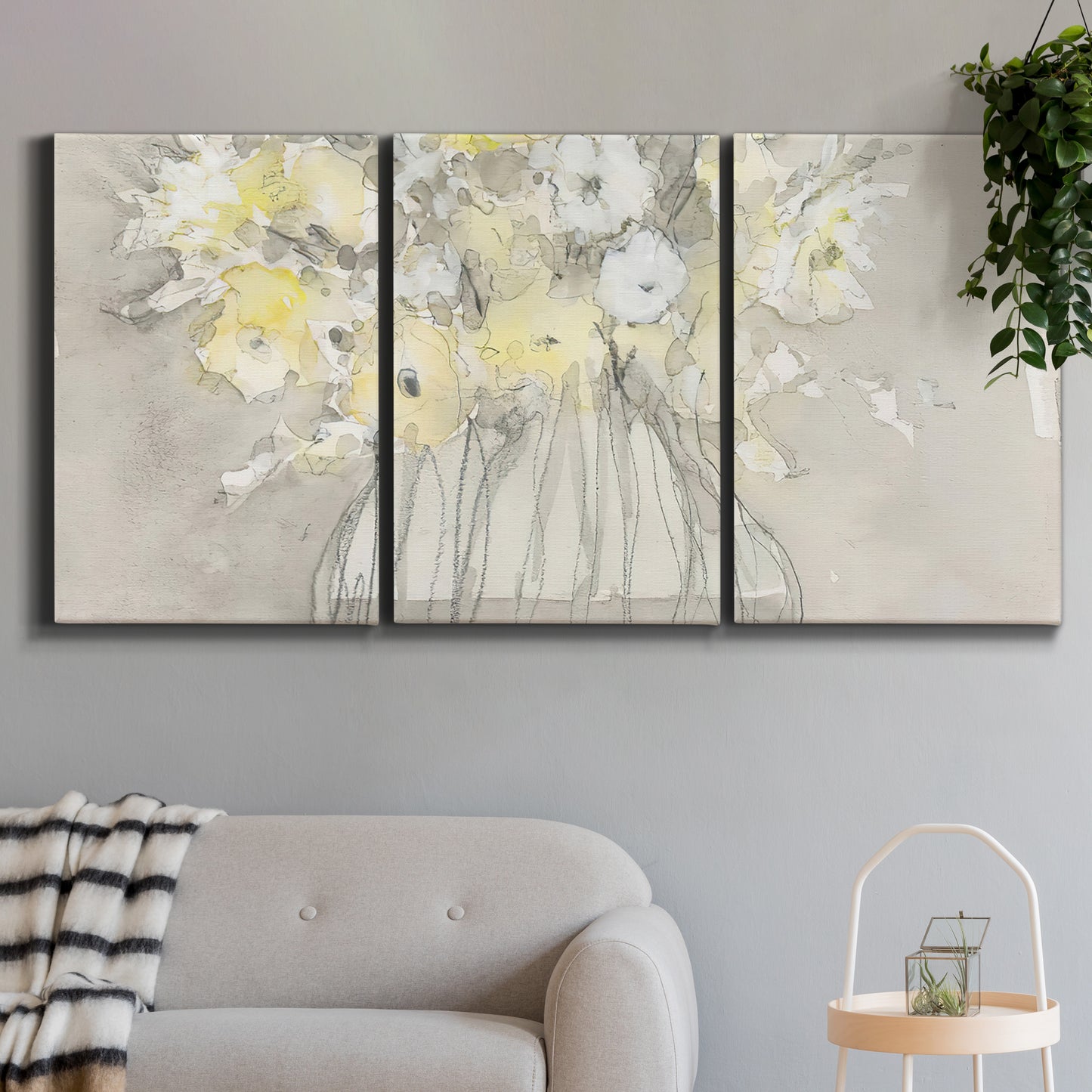 Three-panel canvas wall art featuring vintage floral abstract composition, displayed in a modern living room above a sofa.