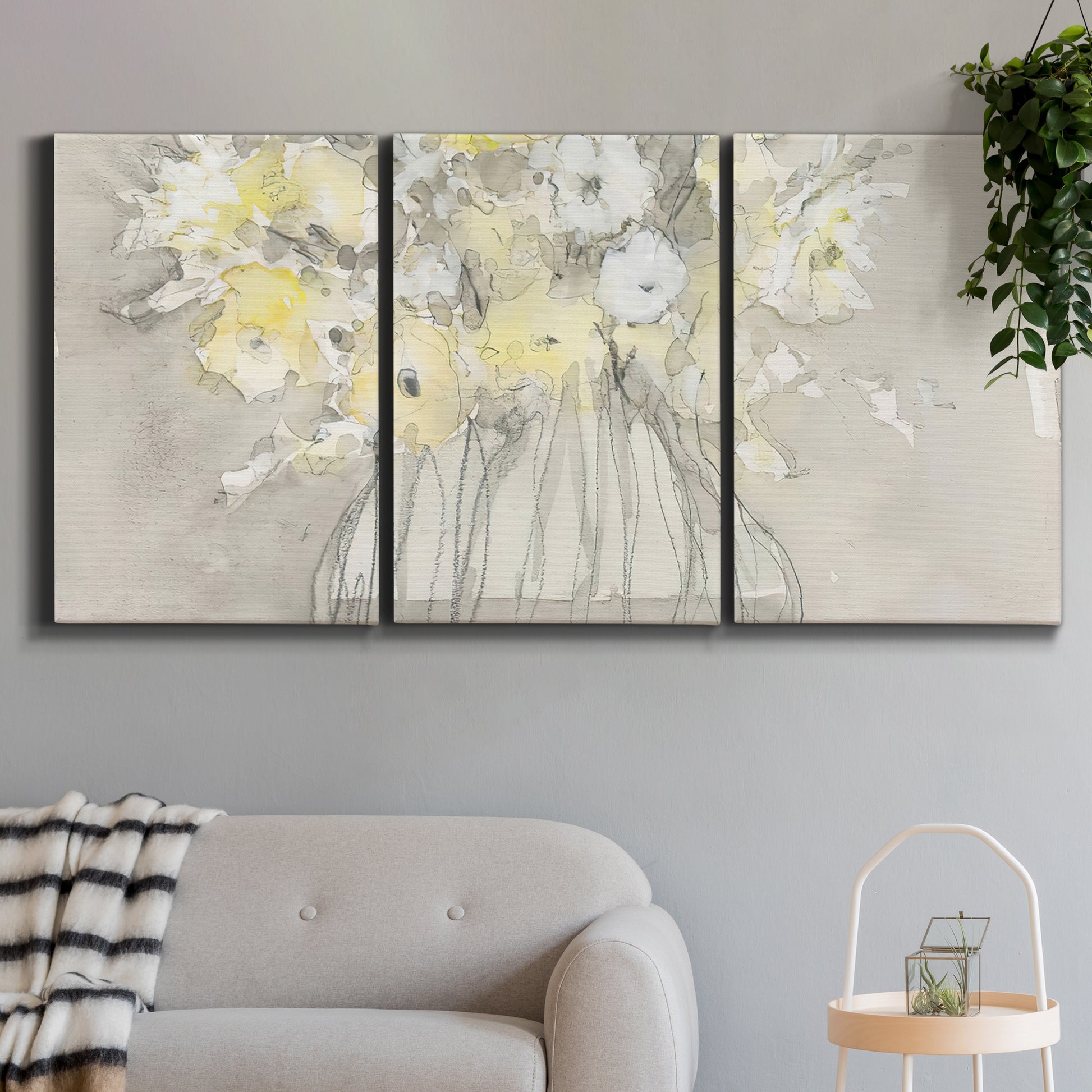 Three-panel canvas wall art featuring vintage floral abstract composition, displayed in a modern living room above a sofa.