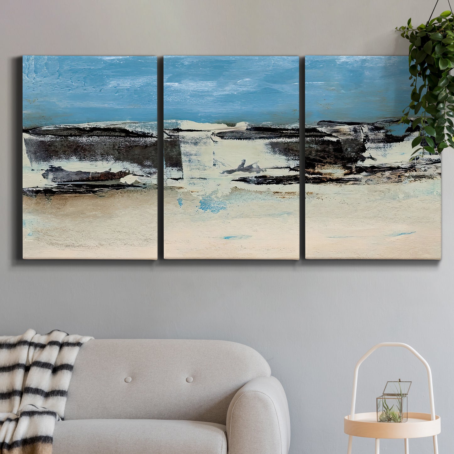Three-panel canvas wall art featuring abstract bridge landscape in cyan, displayed in a modern living room above a sofa.