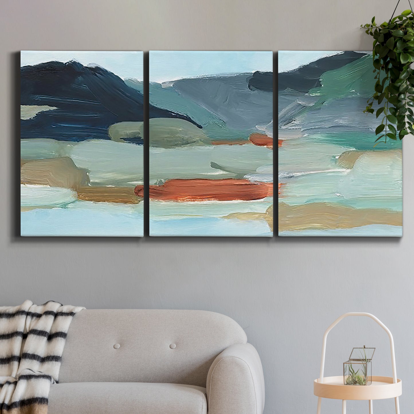 Three-panel canvas wall art featuring vibrant abstract with dramatic motion, displayed in a modern living room above a sofa.