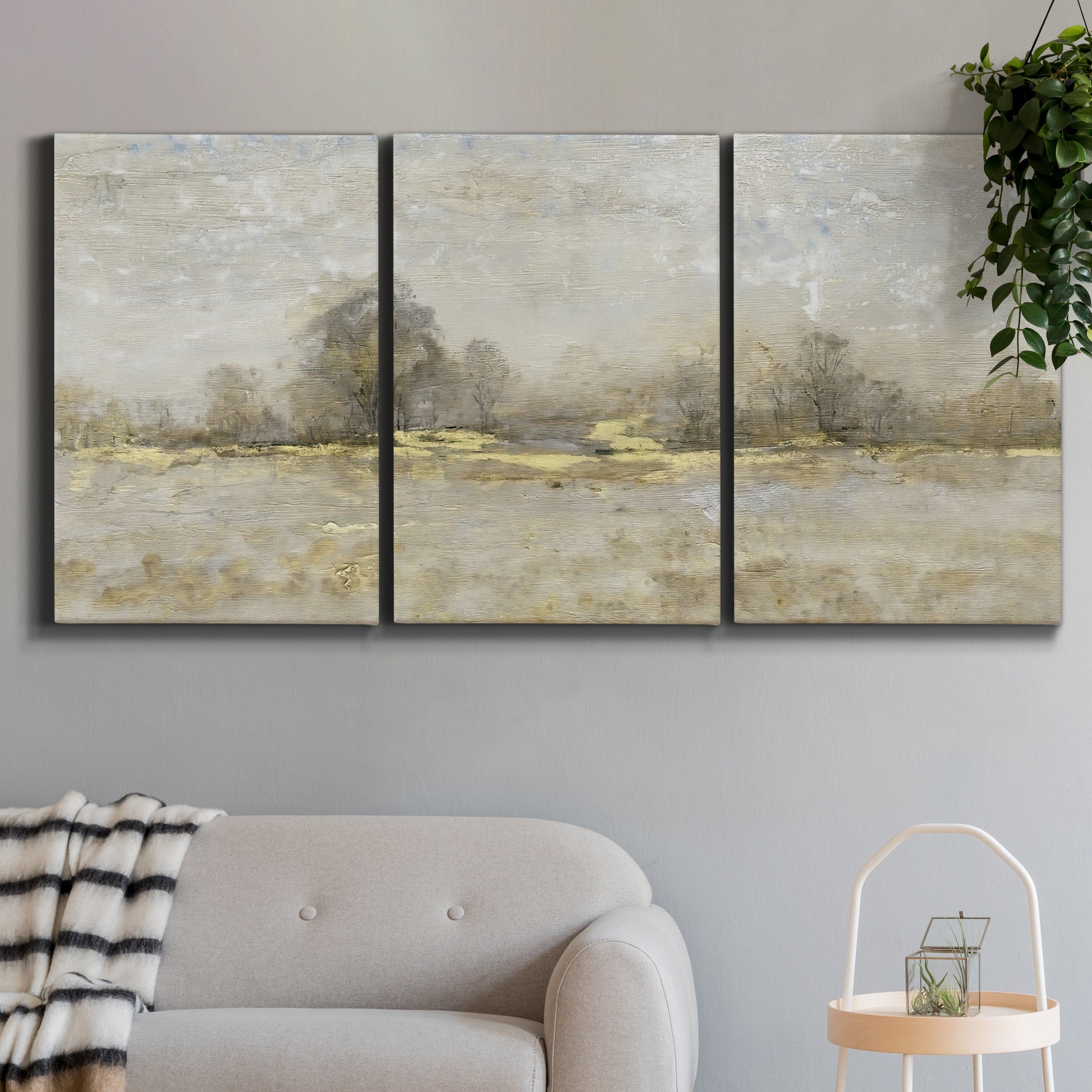 Three-panel canvas wall art featuring late season rural harvest fields, displayed in a modern living room above a sofa.