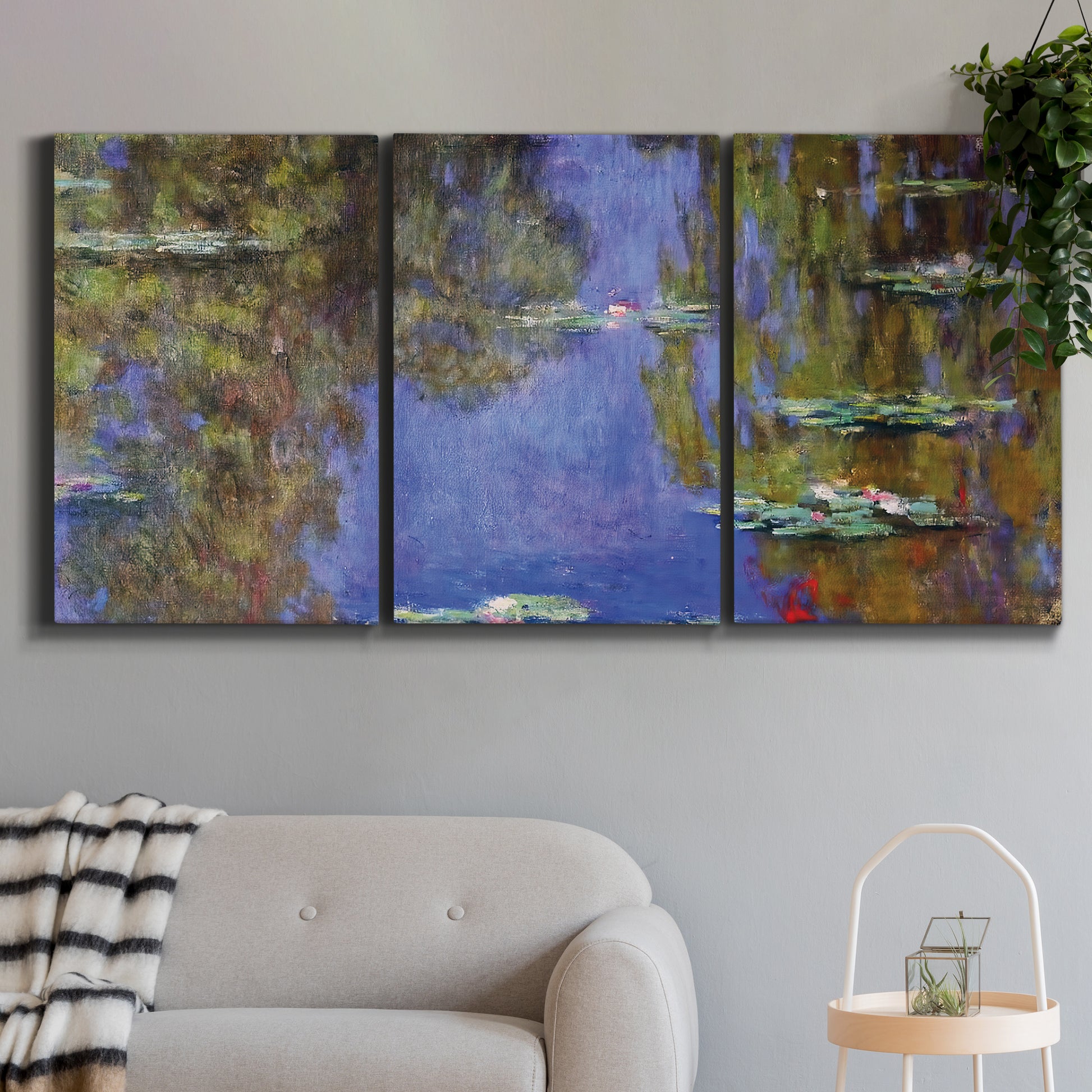 Three-panel canvas wall art featuring blue and purple water lily pond, displayed in a modern living room above a sofa.
