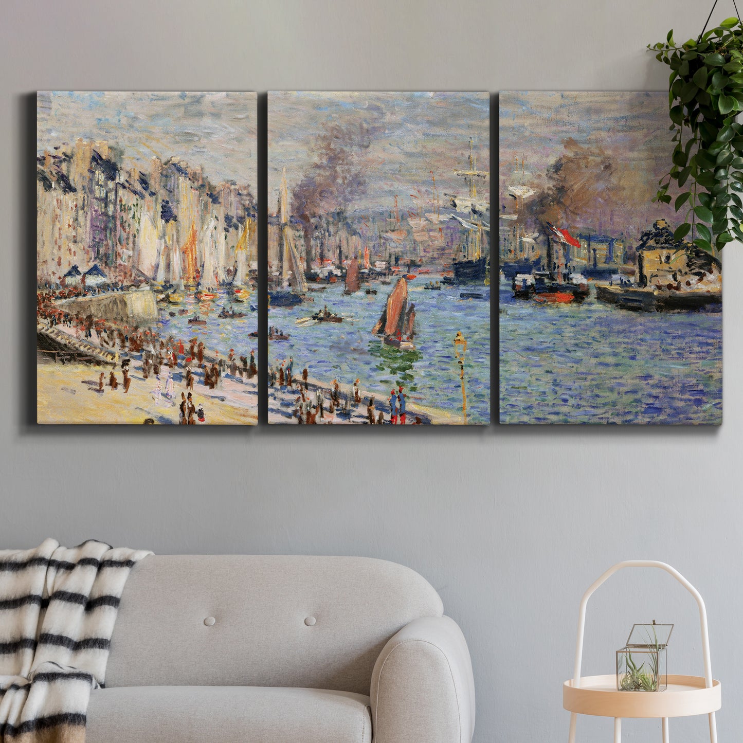 Three-panel canvas wall art featuring evening harbor with reflections, displayed in a modern living room above a sofa.