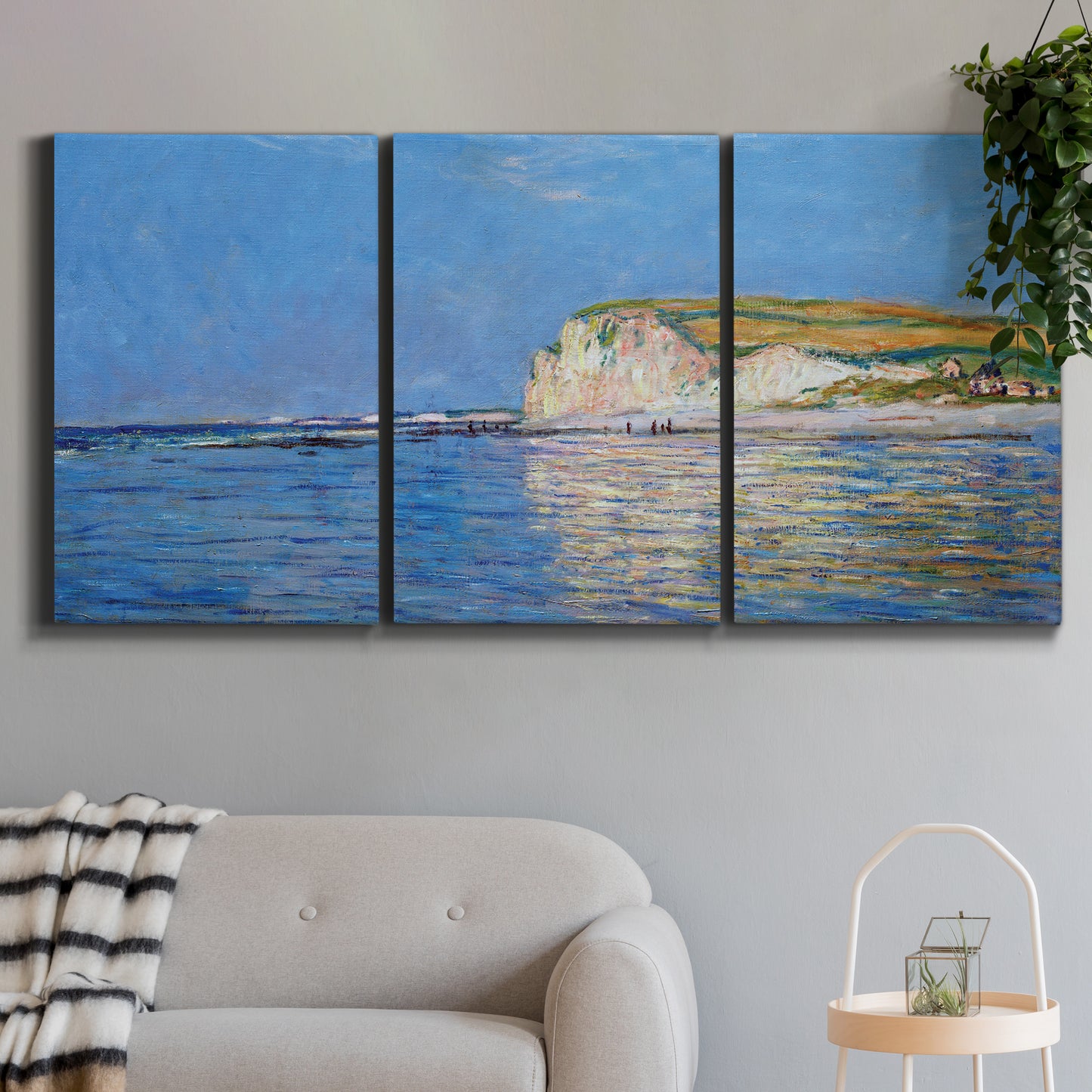 Three-panel canvas wall art featuring white cliffs rising above sea, displayed in a modern living room above a sofa.