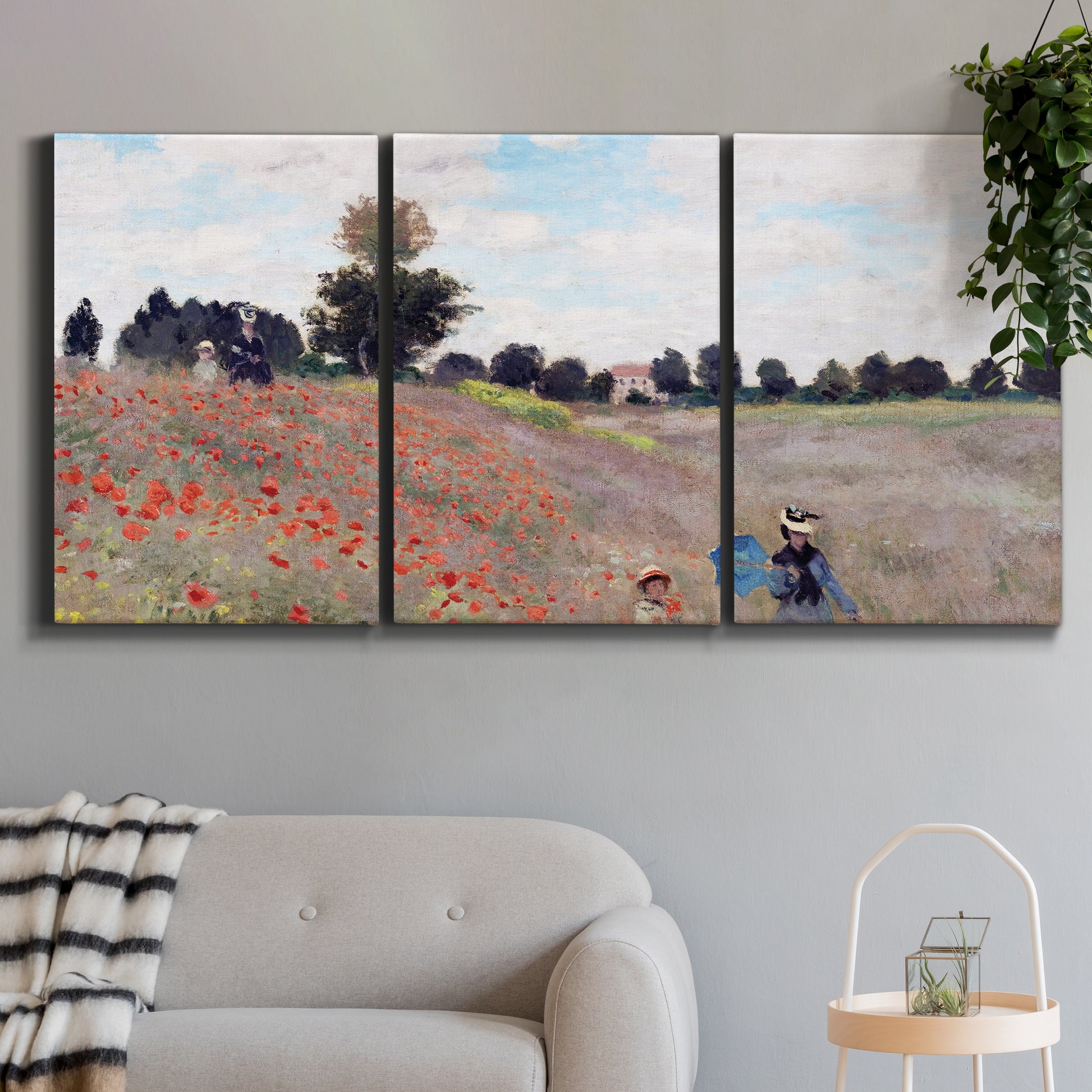 Three-panel canvas wall art featuring poppy field stretching across meadow, displayed in a modern living room above a sofa.