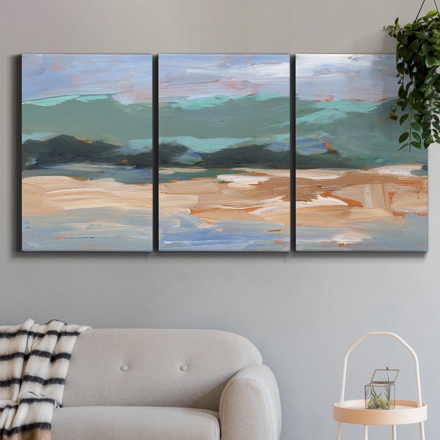 Three-panel canvas wall art featuring abstract landscape composition study, displayed in a modern living room above a sofa.
