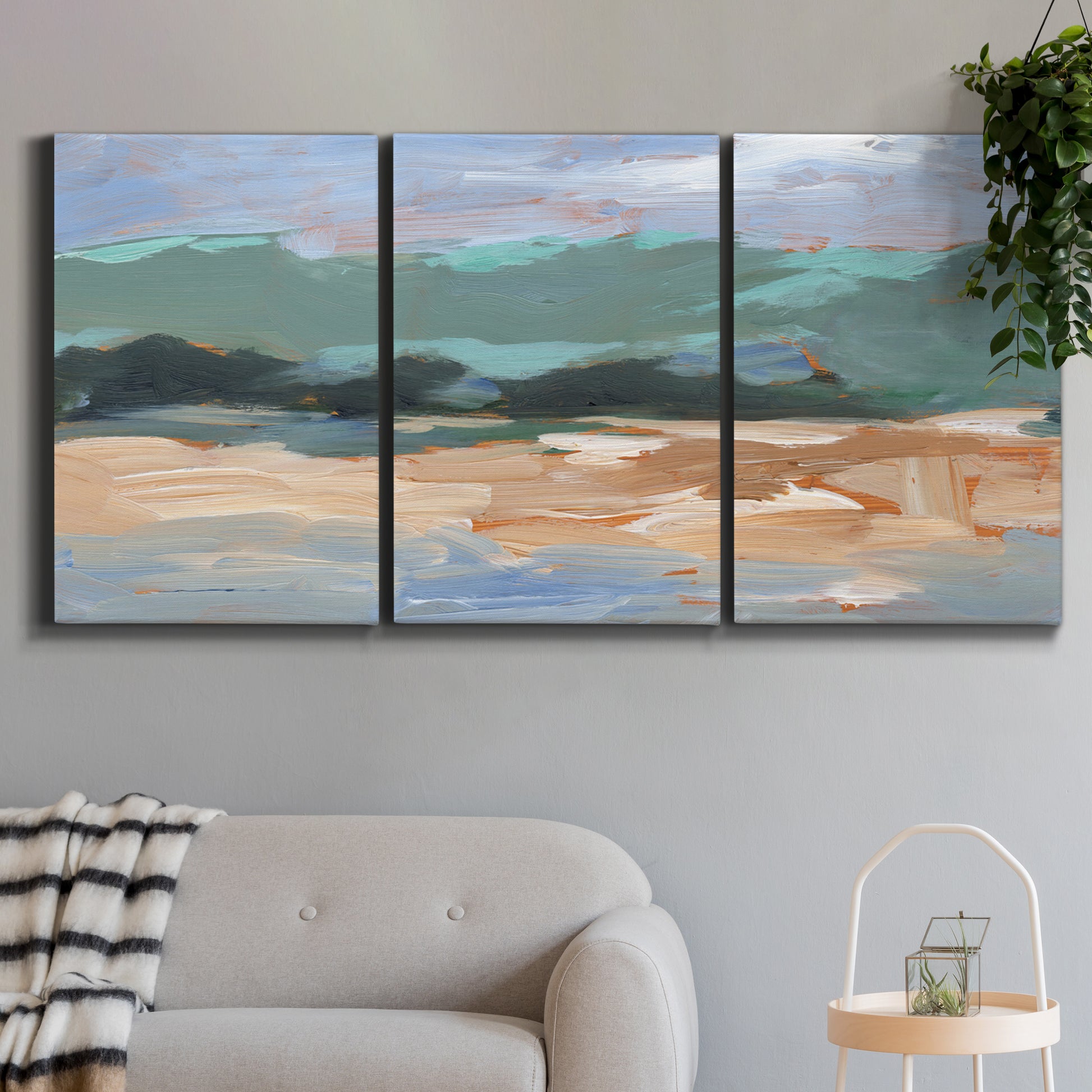 Three-panel canvas wall art featuring abstract landscape composition study, displayed in a modern living room above a sofa.